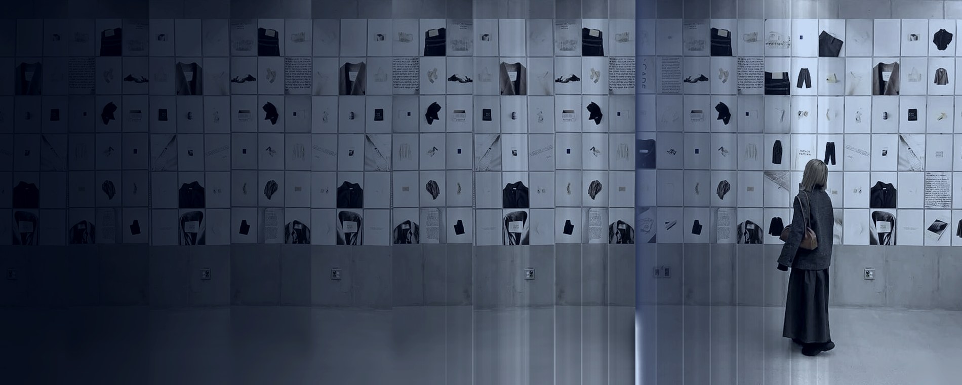 A gallery wall of garment and material studies viewed by one visitor, fashion brand visuals by DE Agency