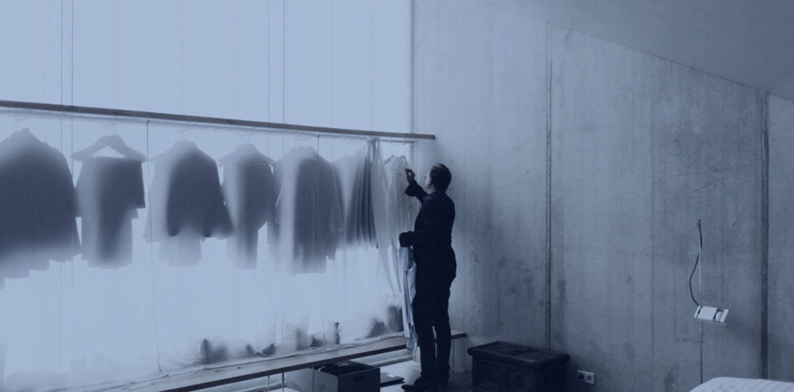 A rail being dressed behind sheer fabric, fashion brand events and customer relationships