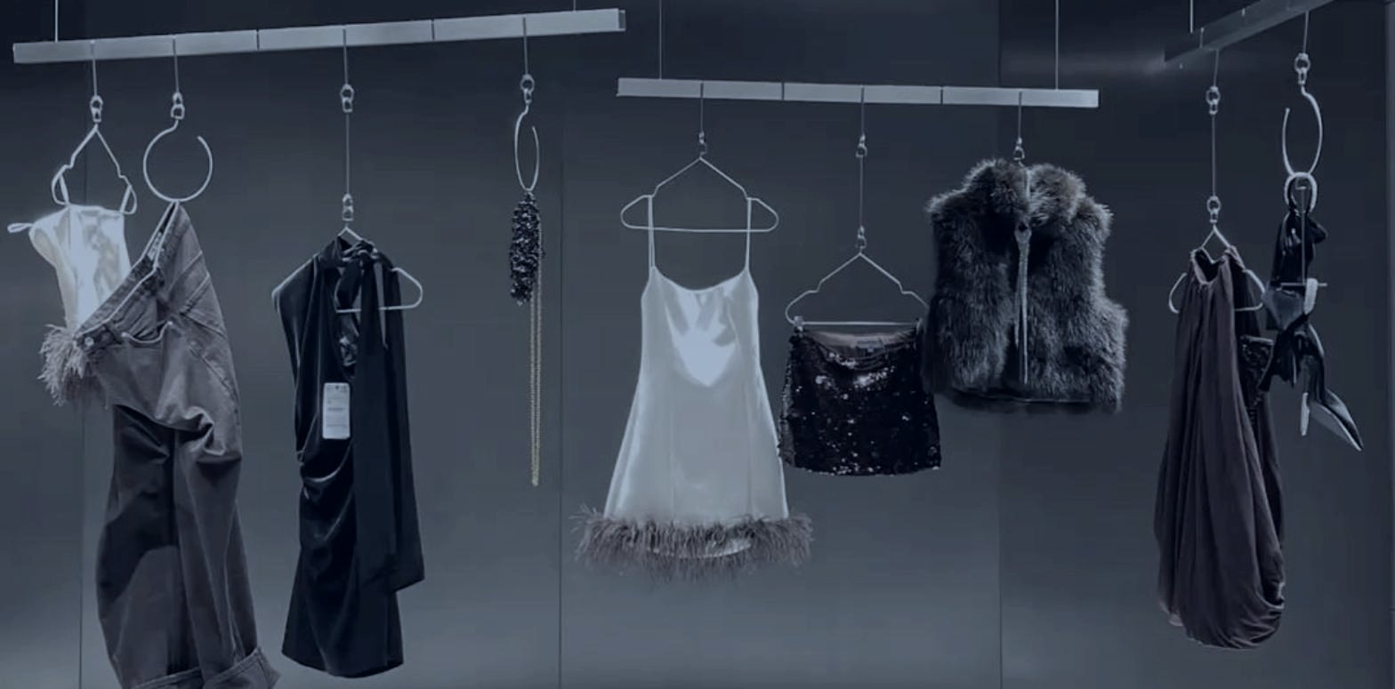 Pieces suspended against a dark wall, a fashion collection presented the way a buyer expects